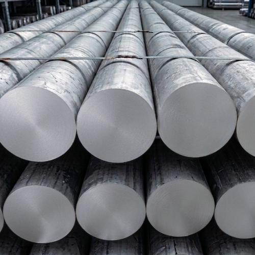 Large inventory of 6082 aluminium billets stacked on racks in a clean, modern metal distribution center.